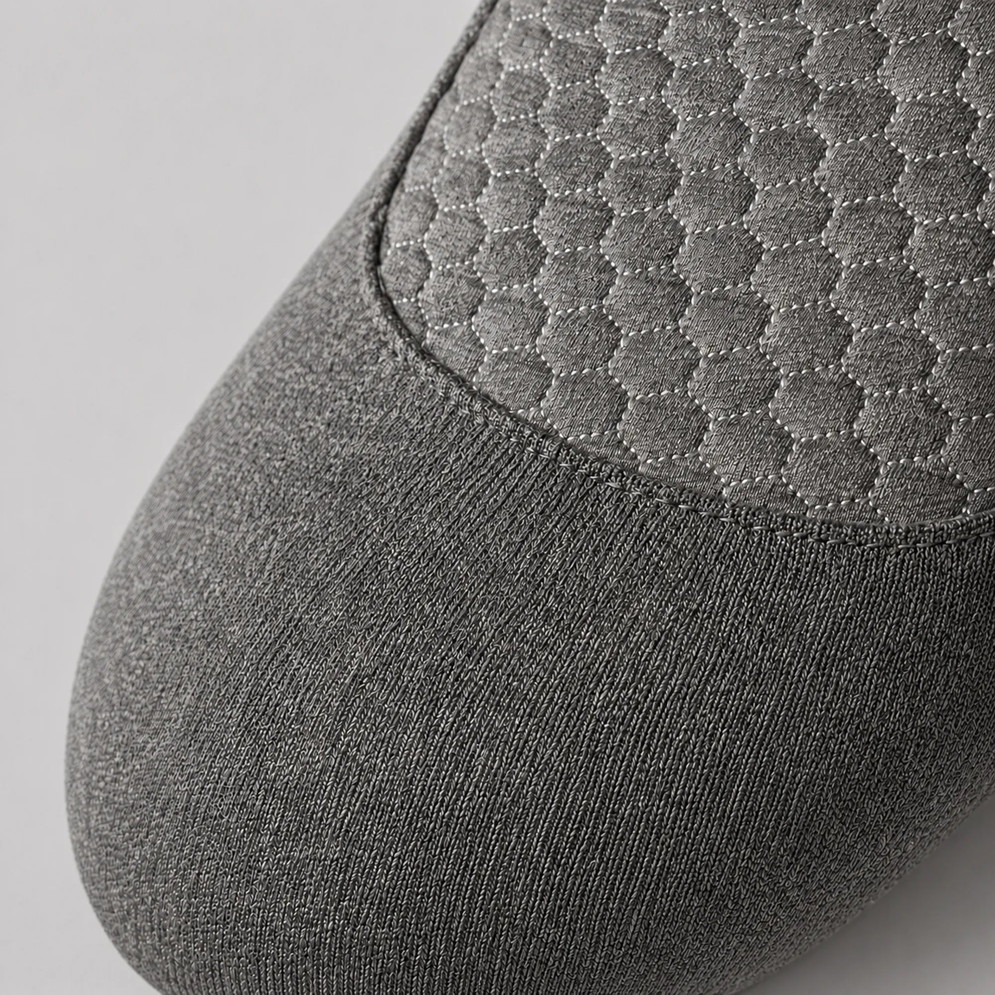 Close view of the honeycomb quilted panel and knitted grey cover