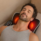 Man reclining on a sofa with the heated cushion behind his neck and shoulders