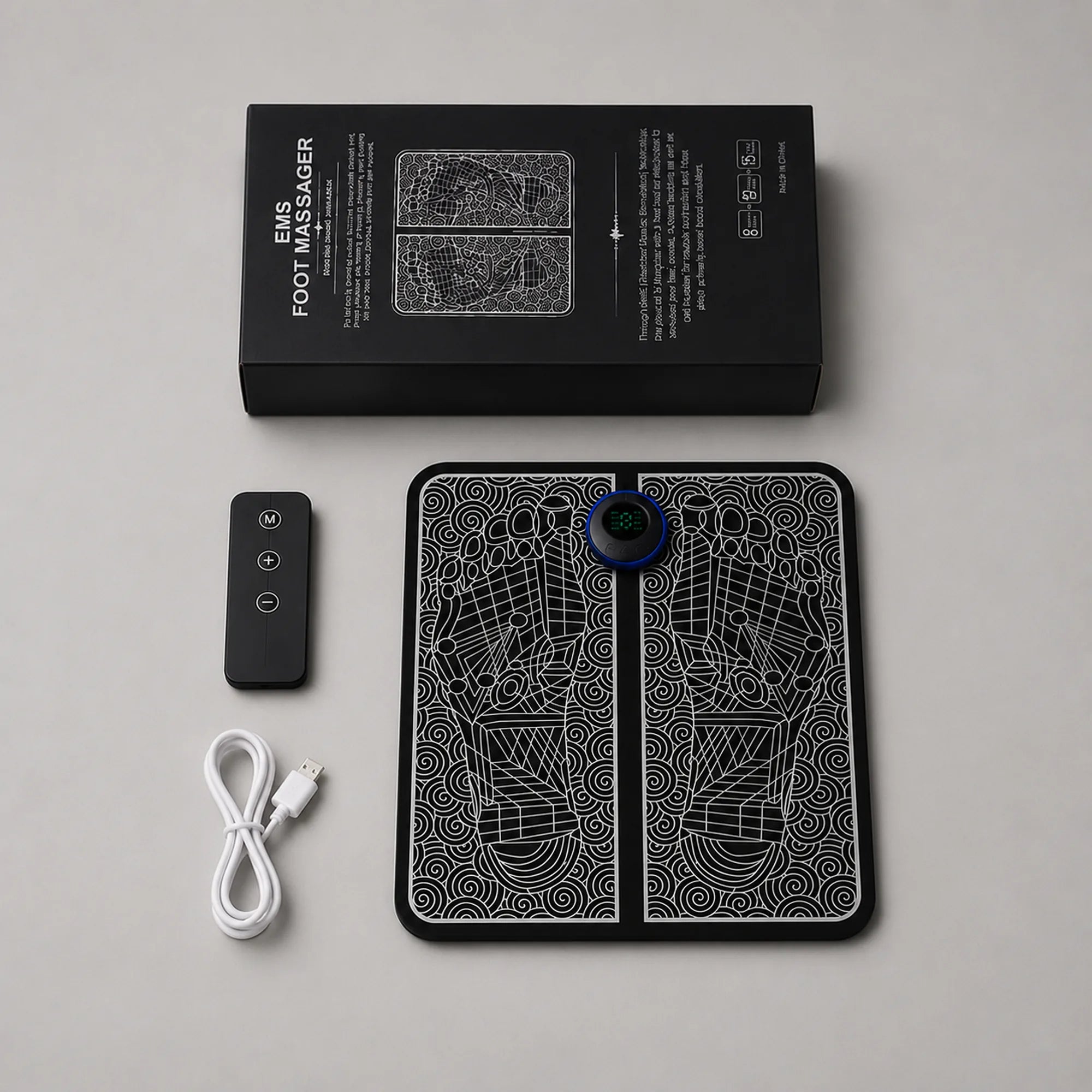Box contents laid out: foot massager pad, wireless remote and USB charging cable