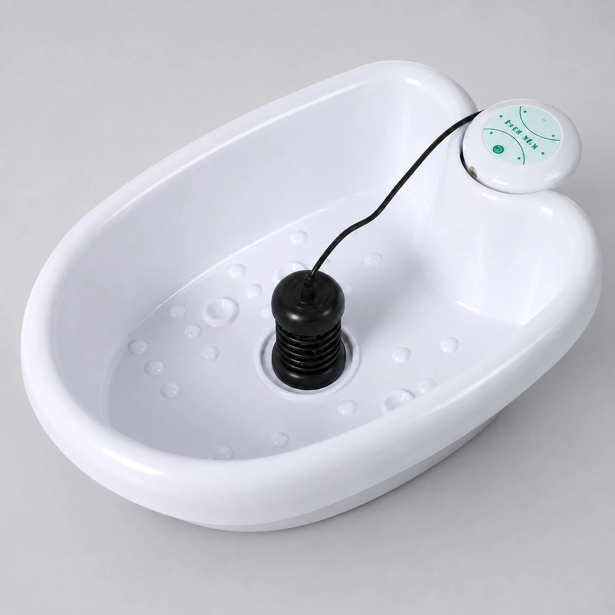 Empty ionic foot spa basin, angled view, with the ionizer array and remote control attached