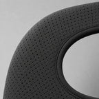 Close-up of the shoulder brace's perforated breathable strap fabric, showing the mesh weave and stitched seam